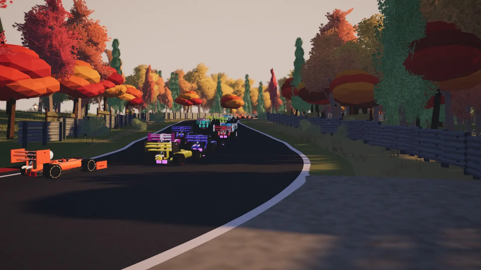 The Little Engines field streams through an autumn forest circuit, seen from the trackside camera